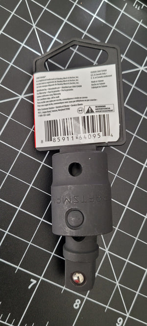 Black tool with a barcode label on a grid background