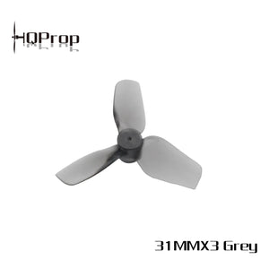 A three-blade grey plastic drone propeller on a white background, with the HQProp logo in the top-left corner and the text '31MMX3 Grey' in the bottom-right corner.