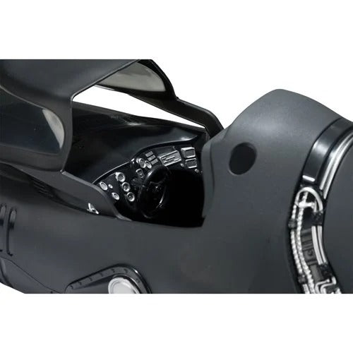 Close-up of a black motorcycle helmet with reflective visor on a white background