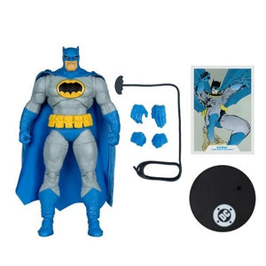 Batman action figure with accessories and promotional material on a white background