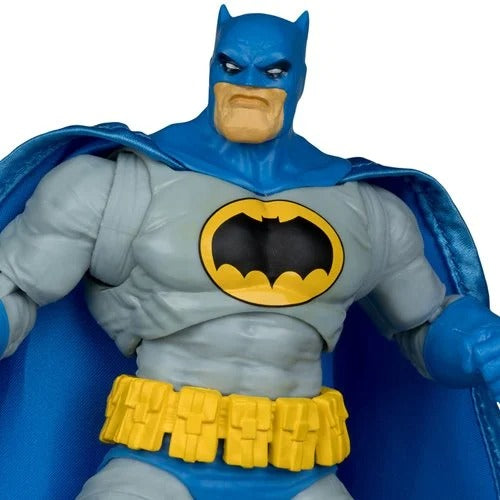 Batman action figure with blue cape and yellow bat symbol on a white background