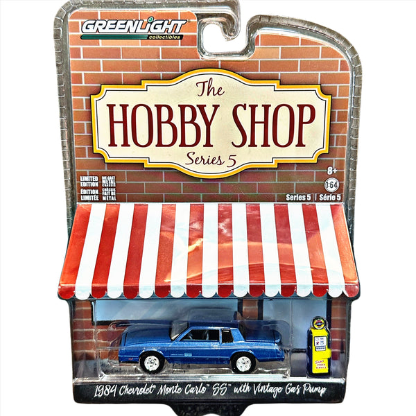 Toy model of a 1984 Chevrolet Monte Carlo 'SS' with vintage gas pump in packaging labeled 'The Hobby Shop Series 5'.