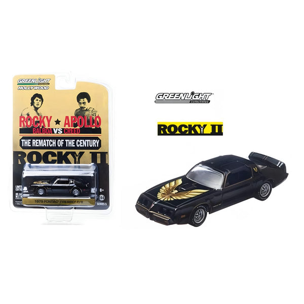 Model car of a black muscle car with gold details next to its packaging featuring 'Rocky II' branding.