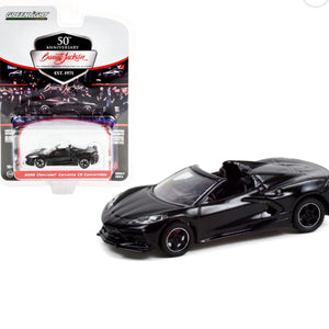Black convertible car model with packaging on a white background