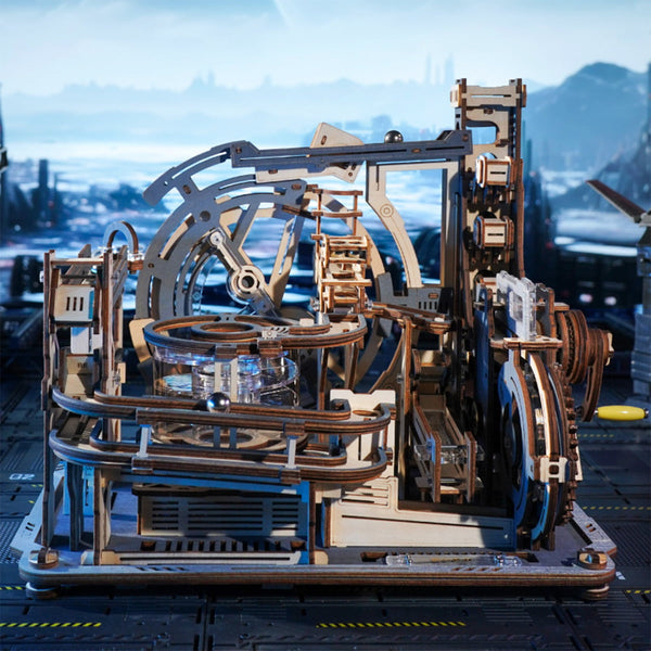 Wooden mechanical model with intricate details against a blurred cityscape background