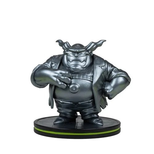 A metallic silver collectible figurine of a cartoon monster character standing on a black circular base with a thin green accent line, isolated on a white background.