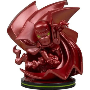 A glossy red Marvel Comics chibi figurine of a character with green eyes and a flowing red cape, posed dynamically on a black circular base with a thin green ring accent.