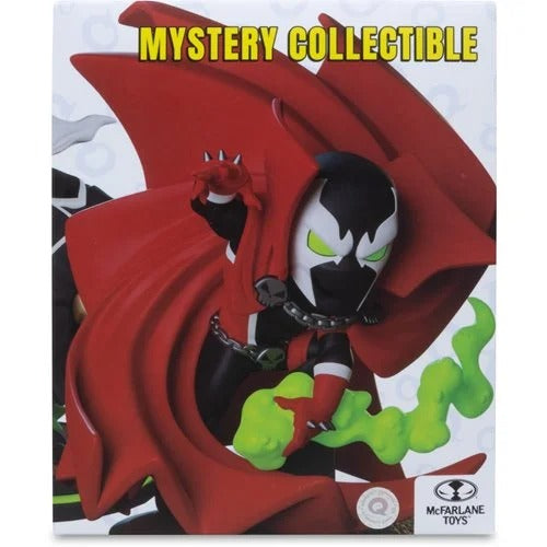 McFarlane Toys Mystery Collectible figure box featuring Spawn with a large red cape, black and white mask, green eyes, and green smoke on a white background with yellow 'MYSTERY COLLECTIBLE' text.