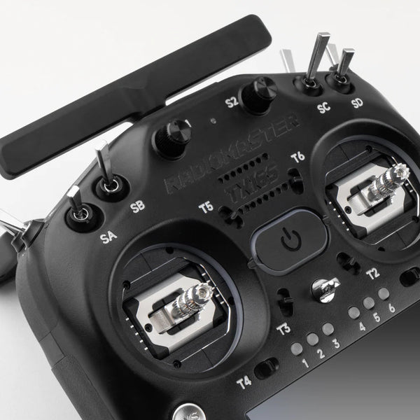 Close-up of a black radio control transmitter with visible branding on a white background