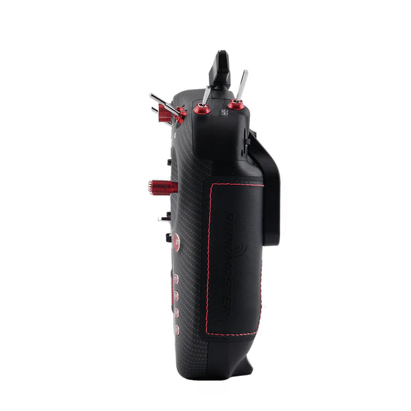 A black handheld remote control with a carbon fiber texture, red stitching, and red adjustment knobs, shown from a side profile view on a white background.