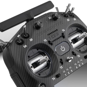 Close-up of a RadioMaster TX16S drone remote control with carbon fiber texture.