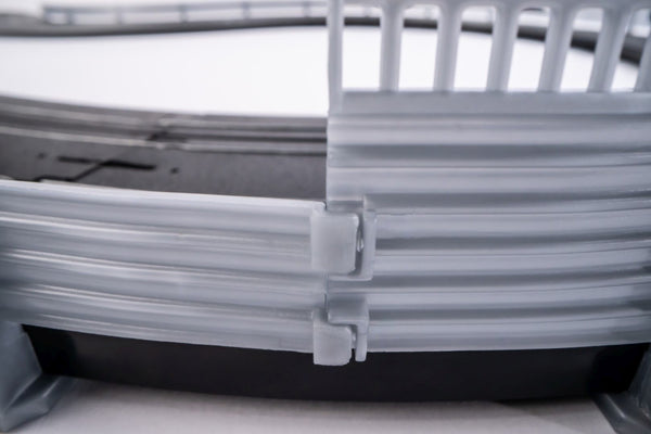 Echo Six Hobbies AFX Racing Close-up of a gray plastic crate with a latch on a white background