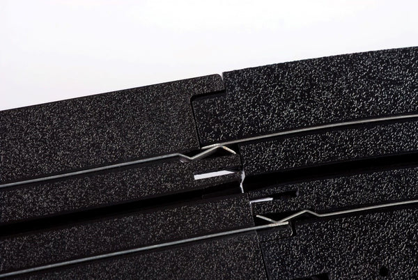Echo Six Hobbies AFX Racing Close-up of a black HO slot car track with a white background