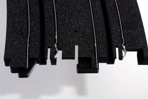 Echo Six Hobbies AFX Racing Close-up of black HO Slot Car track with textured surface on a white background