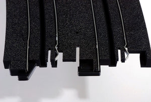 Echo Six Hobbies AFX Racing Close-up of black plastic interlocking puzzle pieces on a white background