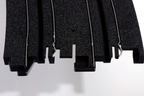 Echo Six Hobbies AFX Racing Close-up of black plastic strips on a white background