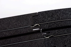 Echo Six Hobbies AFX Racing Close-up of black foam strips with metal clips on a white background