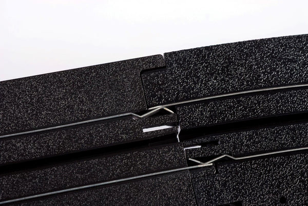 Echo Six Hobbies AFX Racing Close-up of black foam strips with metal clips on a white background