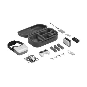 A drone accessory kit arranged on a white background, including a VR headset with strap, a small drone, a handheld controller, a hard carrying case, battery packs, a small motor/propeller component, cleaning tools, and cables.