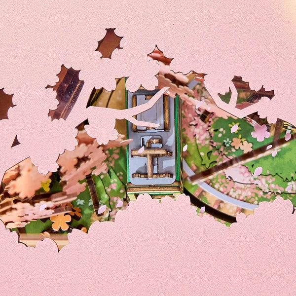 Decorative image with cherry blossoms and a traditional Japanese house on a pink background