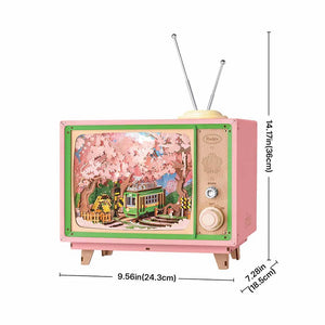 Small pink and green vintage-style TV with a scenic display, dimensions indicated on the right.