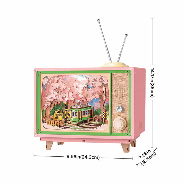 Small pink and green vintage-style TV with a scenic display, dimensions indicated on the right.