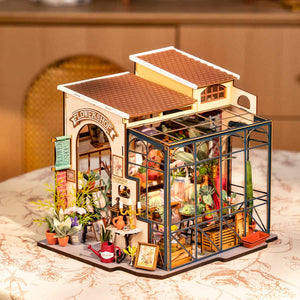 Model of a flower shop with plants and decor on a table