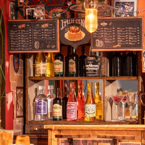 Wooden bar shelf with alcohol bottles and glasses, featuring a 'Menu' board and decorative elements.