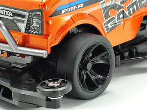 Close-up of an orange and black model car with visible branding on a white background