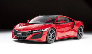Red Acura NSX sports car on a black background
