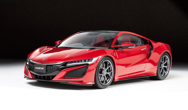Red Acura NSX sports car on a black background