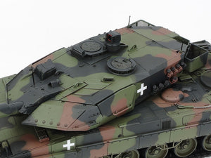 Camouflage military tank with a white cross on a white background