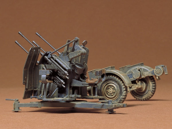Model of a military vehicle with multiple guns on a brown background