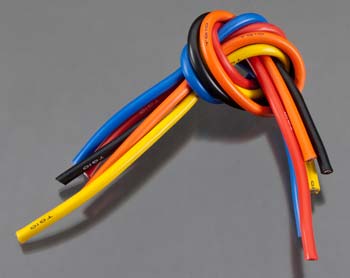 Colorful insulated wires tied together on a gray background