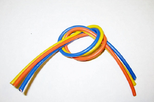 Rainbow colored wires tied in a knot on white background
