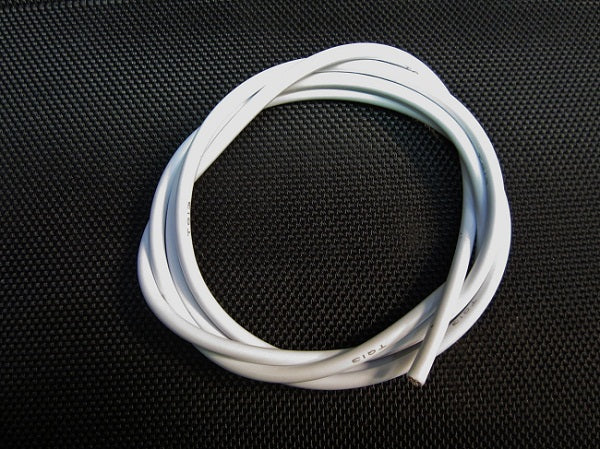Coiled white cable on a black textured background