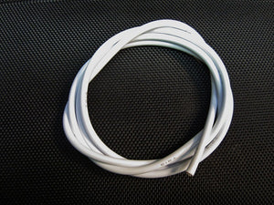 Coiled white cable on a black textured background