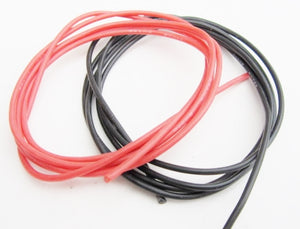 Red and black wires coiled on a white background