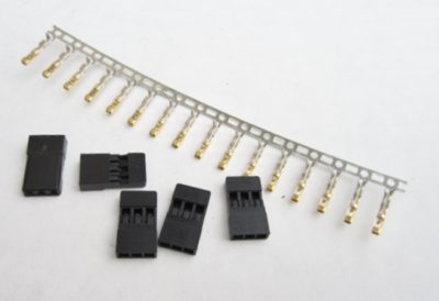 Set of black connectors with gold contacts on a white background