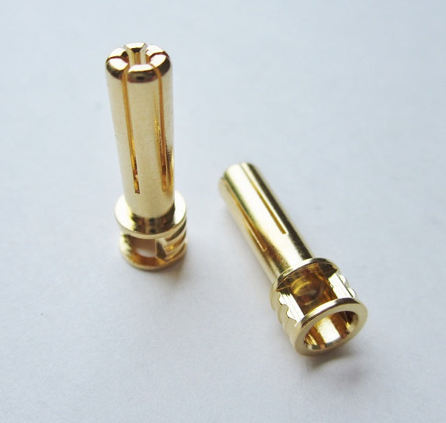 Two gold metal connectors on a light gray background