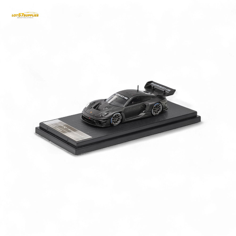 Black sports car model on a display stand with clear acrylic cover