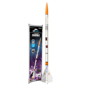 Model rocket with an orange nose cone, white body, and fins displayed next to its packaging showing the rocket flying against a starry space background, highlighting its educational and STEM learning purpose.