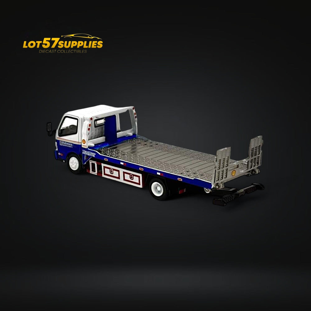 Model flatbed truck with detachable car carrier on a dark background, featuring 'LOT57SUPPLIES' branding.