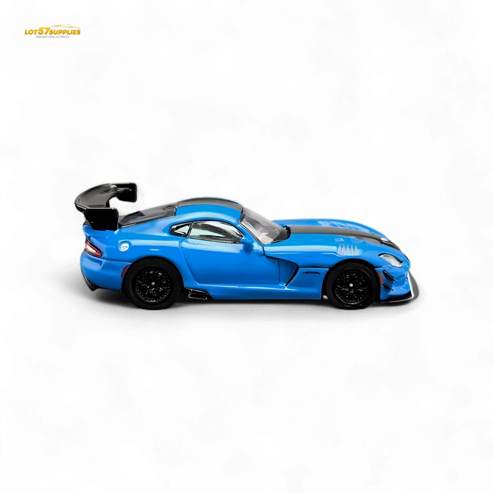 Blue sports car model on a display stand with additional car and packaging in the background.
